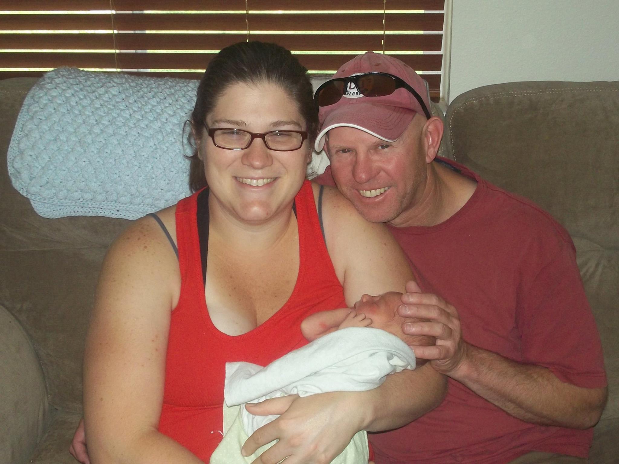 Beautiful Births couple holding new baby after homebirth.