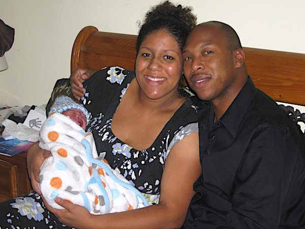 Beautiful Births couple holding new baby after homebirth.