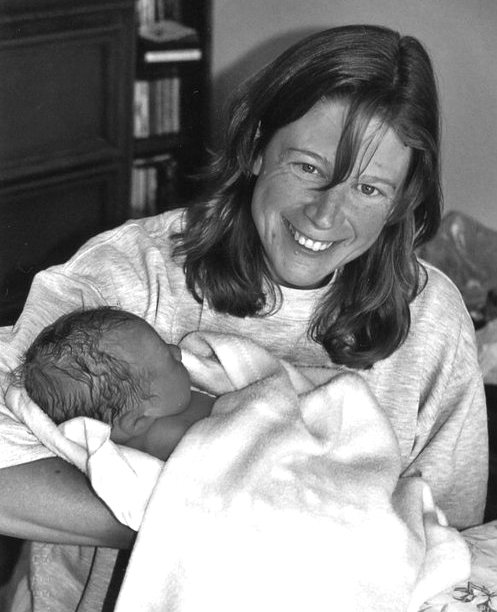 Beautiful Births New mother holding baby after at home birth.