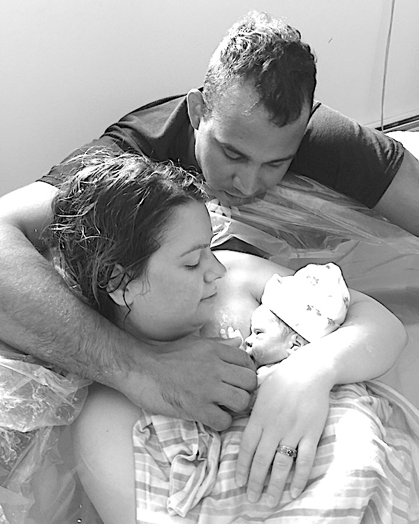 Beautiful Births couple holding new baby after homebirth.